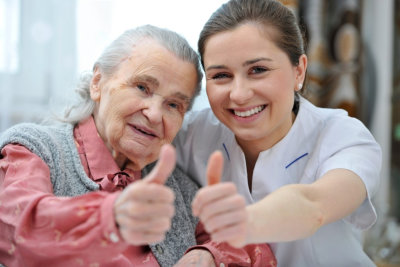 caregiver and senior woman smiling