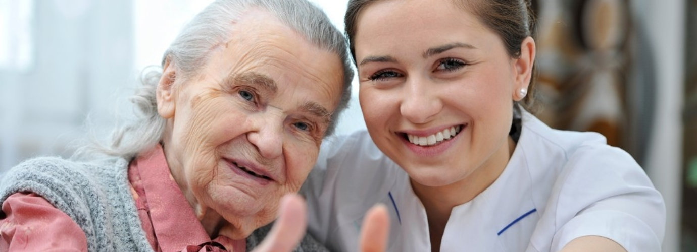 caregiver and senior woman smiling